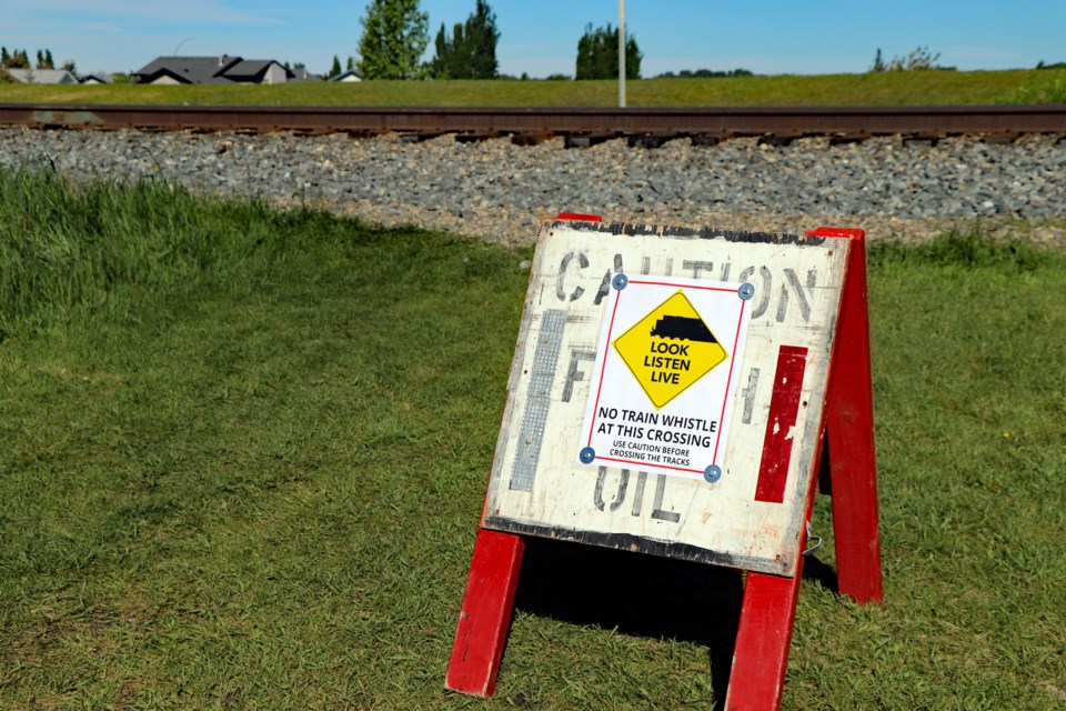 Temporary caution sign put up last week at the unregulated White Rock Crossing near the Innisfail Schools Campus. Johnnie Bachusky/MVP Staff