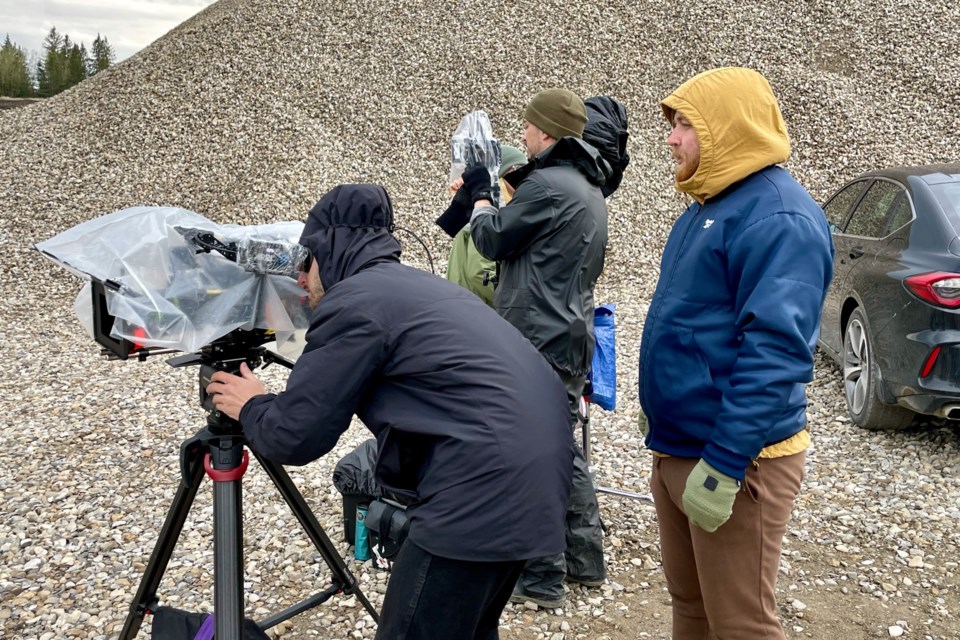 Despite some rain while shooting outdoors at the Sundre Contracting gravel yard on May 19, the cast and crew with Alberta-based Numera Films nevertheless managed to successfully wrap up the scenes they’d planned for that day. Photo courtesy of Jon Allan