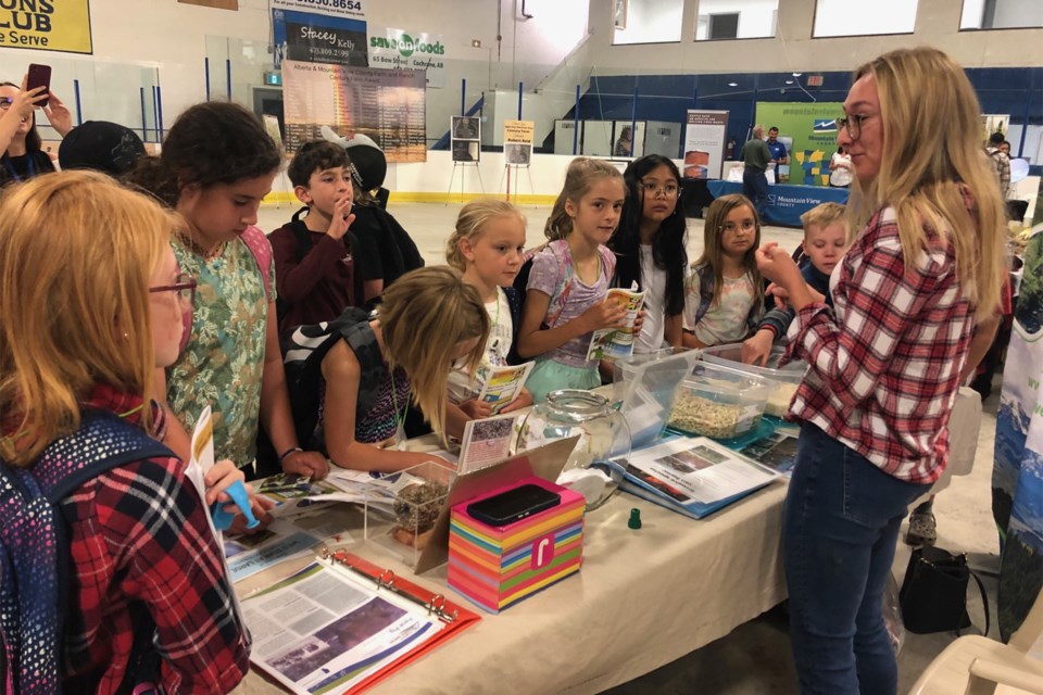 Students look over the Alberta Invasive Species Council booth in the curling rink on June 9.
Dan Singleton/MVP Staff