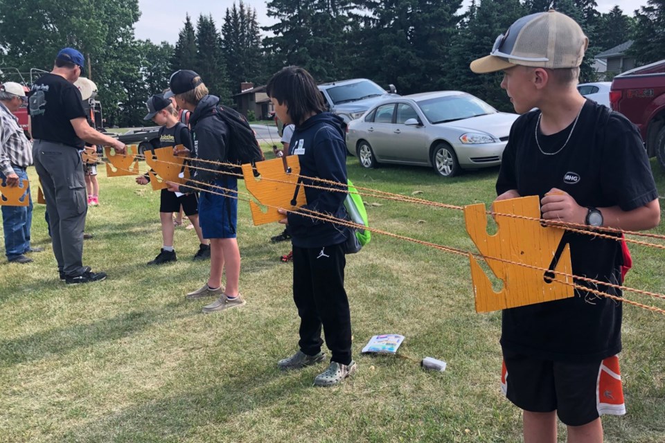 Students participate in a rope-making exercise sponsored by Richard Ross Rope Making outside the community hall.
Dan Singleton/MVP Staff