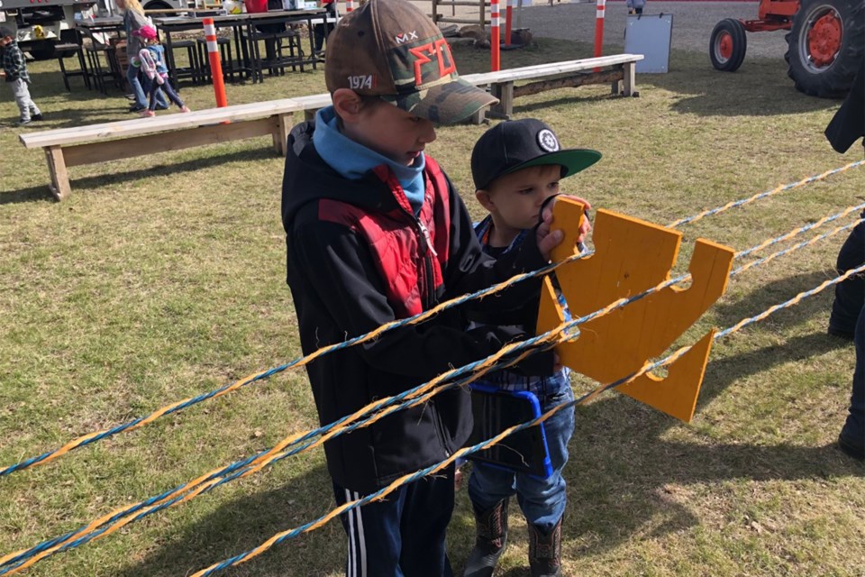 Nicolas, 8, and Felix, 5, help with a roping making demonstration on Saturday, May 14 at Aggie Days. Richard Ross was the instructor for the rope making activity.
Dan Singleton/MVP Staff