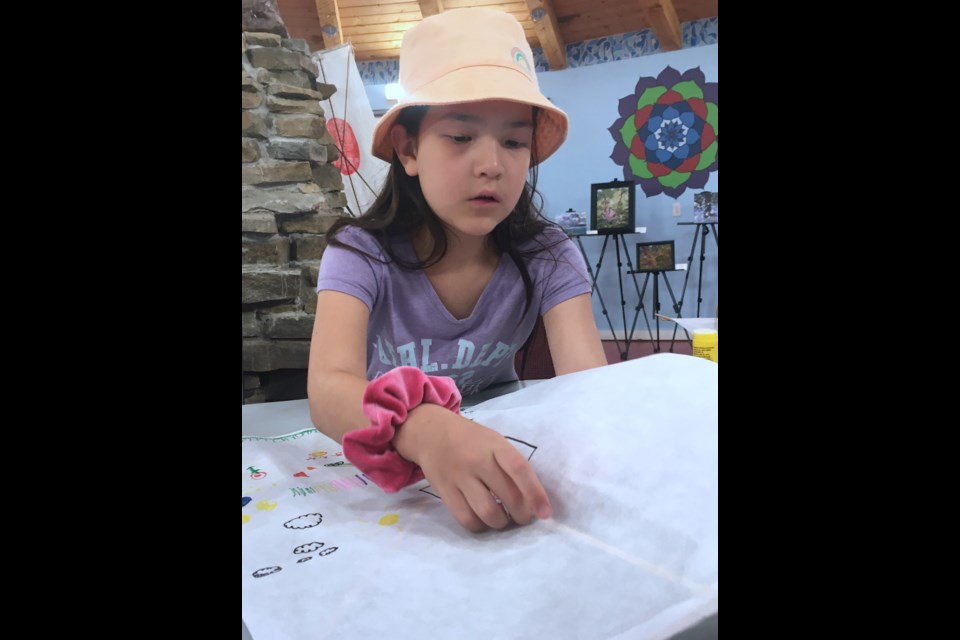 EmiLiya, 7, who was joined by her two younger brothers and mom Megumi, learned how to make a Japanese kite during a craft session led by library manager Joy Willihnganz. While the library helped with some of the programs, such as a Japanese kite making craft session, the museum was the central hub that hosted on Sept. 22-23 all of the activities and displays.  
Simon Ducatel/MVP Staff