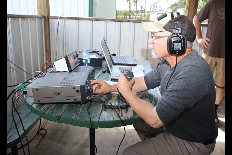 A ham radio operator attempts to communicate with fellow enthusiasts from around the world during  the Central Alberta Amateur Radio Club’s annual Field Day at the Hillcrest Community Hall.