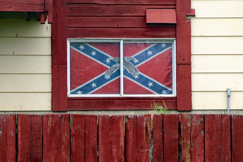 A Confederate flag covers the entire ground floor window of an apartment in east Innisfail that is easily seen from the street. Johnnie Bachusky/MVP Staff