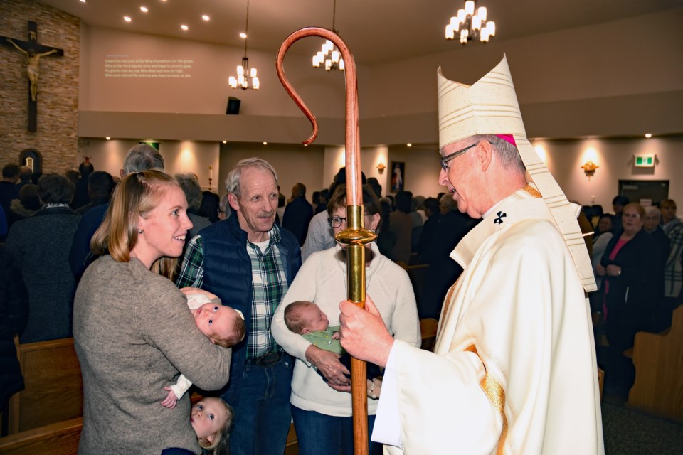 An Innisfail family proudly meets the Archbishop of Edmonton Richard Smith. Mother Dianne Bennet, left, brought her children, including six-week-old twins Audrey and Jacob, to meet Bennett for Sunday mass on Nov. 26 at Innisfail's Our Lady of Peace Catholic Church. Bennett is holding Audrey, and to her right is father John Buyks, and then mother Corry holding twin baby Jacob. Photo by Maymie O’Dwyer