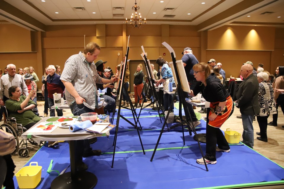 A crowd watches as local artists create their paintings during one of the 20 minute rounds at the Battle of the Brushes event in Olds on Saturday, March 25. 
Doug Collie/MVP Staff