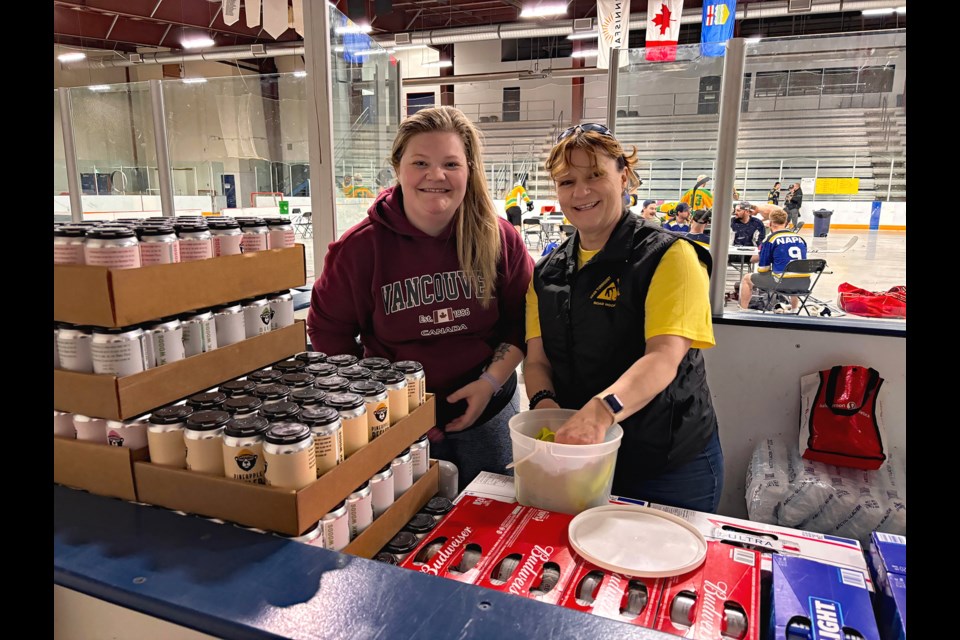 Longtime Innisfail volunteer Darlene Thompson (right) is with her daughter Jasmine O'Donoghue on April 20 helping out at the 27th Annual Spring Fever Road Hockey Tournament, just 12 hours after winning this year's Innisfail Citizen of the Year Award. Johnnie Bachusky/MVP Staff