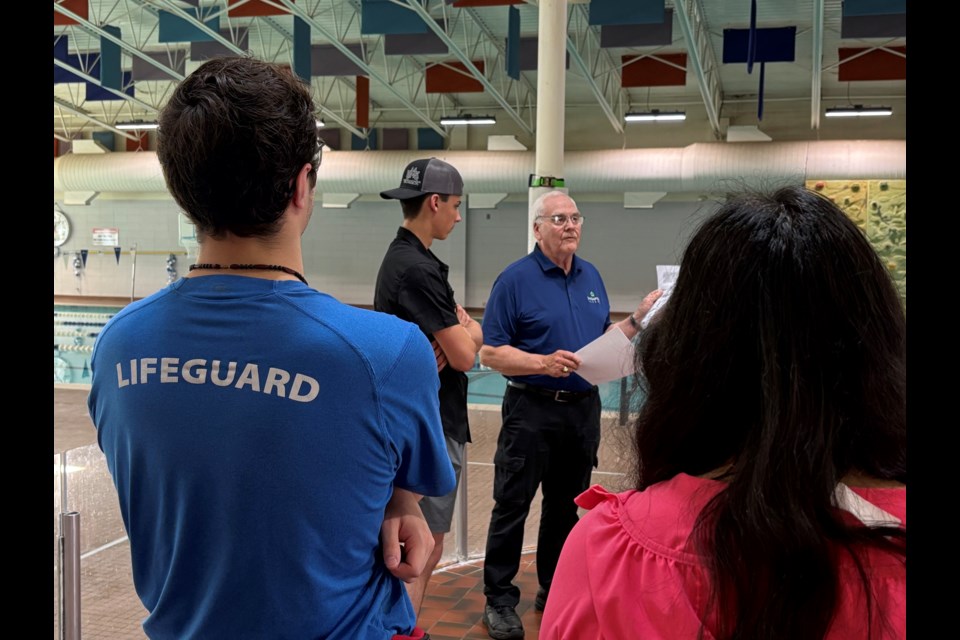 Innisfail's Gavin Bates (centre-right) makes a presentation on June 27 at the Innisfail Aquatic Centre to family and friends of 18-year-old Van Robinson (centre-left) who is the winner of the 8th annual Bates Wardle Award. Johnnie Bachusky/MVP Staff