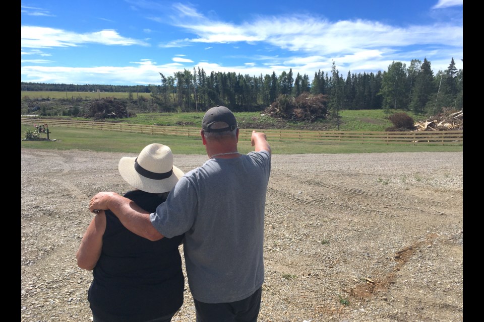 Judy and John Bargholz survey on Monday, Aug. 29 the view from their property overlooking Twp. Rd. 320, more commonly known in the community as Bergen Road, which is located southeast of Sundre. Large piles of felled trees now sit where once a tree stand acted as a natural barrier. The forested area was largely cleared out by the July 7 tornado-producing storm that hit hard several properties in the immediate area.
Simon Ducatel/MVP Staff