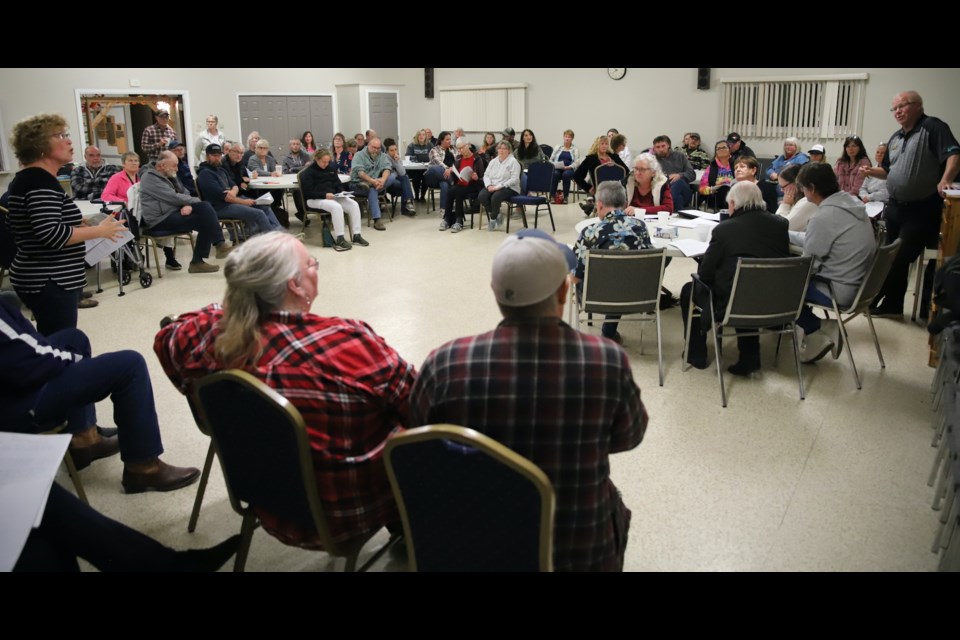 Resident Marietta Tuckwell, far left, addresses Town of Bowden Mayor Robb Stuart, far right, during the open house for the town’s proposed community standards bylaw, held Oct. 4 in the Event Centre.