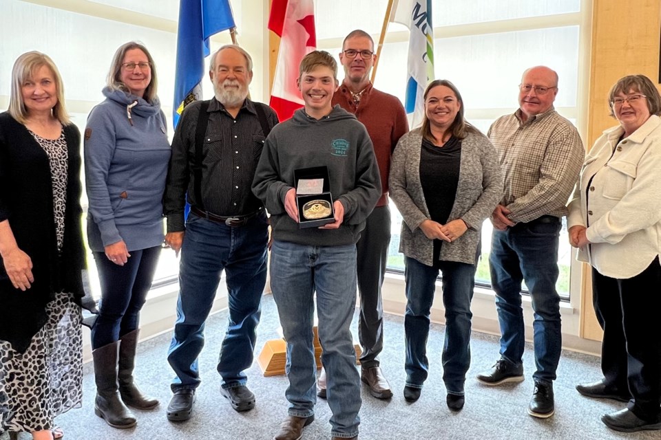 Zander Ewert, centre, poses for a photo with county council on May 21.