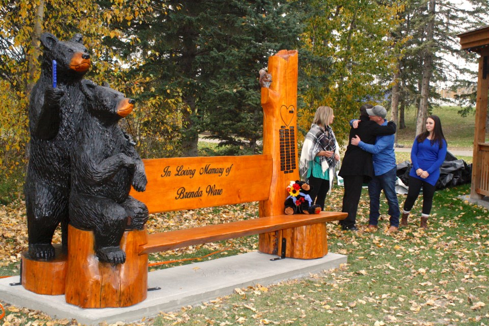 From left, Alishia Holzapfel, Cody Fahey, Steve Holmes and Emmi Holmes, close friends of Brenda Ware who considered her family, participated on Saturday afternoon in the unveiling of the memorial bench at the Sundre Greenwood Campground's community gazebo.
Simon Ducatel/MVP Staff