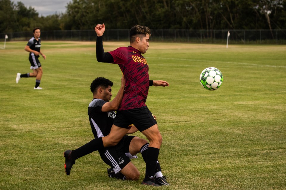 Dilan Vargas, right, of the Olds College Broncos, battles for possession of the ball against the Lethbridge College Kodiaks in preseason play on Aug. 27, 2022.