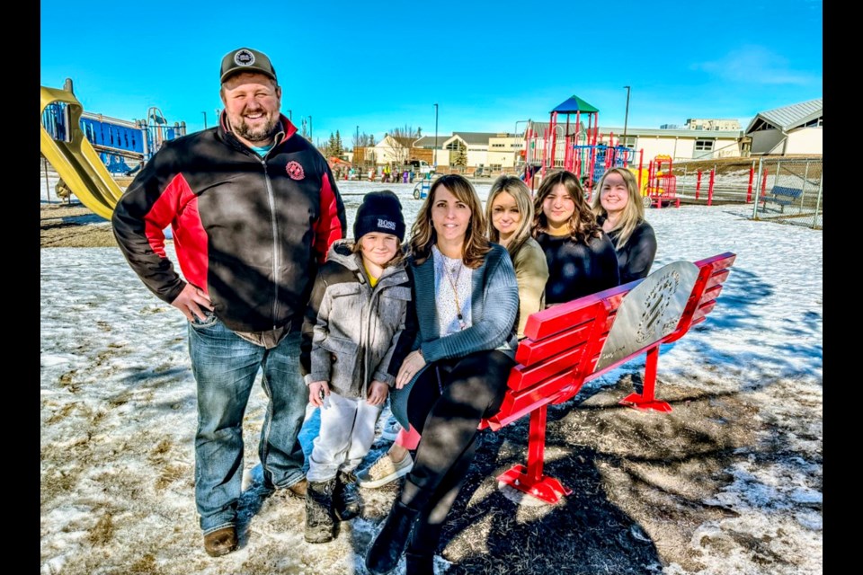There was a celebration last week at Innisfail’s École John Wilson Elementary School to mark the installation of the town's first Buddy Bench. From left to right is Donnie Hill, president of the Innisfail Kinsmen, his son Sylas, Janice Savage, vice-principal of École John Wilson; TaShawna Roberts, family school wellness worker; Velecia Miller, practicum student and school principal Angela Warke. Johnnie Bachusky/MVP Staff