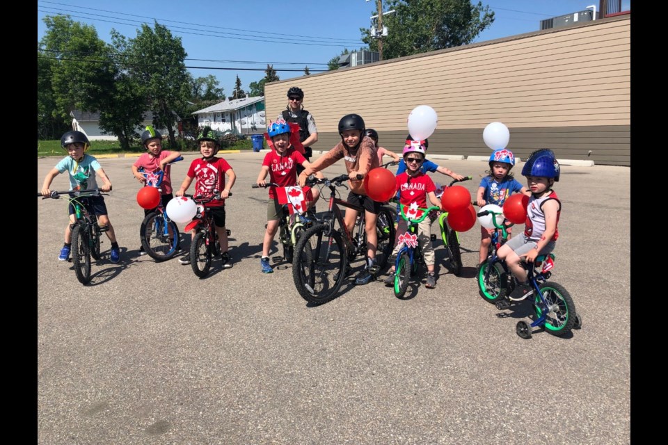 CANADA DAY IN CARSTAIRS — Carstairs youngsters show off their best Canada Day outfits during a bike rodeo in town on July 1. The event saw the kids learn all about bike safety, including the use of proper hand signals and the need to always wear a helmet when cycling, says instructor and town peace officer David Peters. "We want to make sure everyone is as safe as possible," he said.
Dan Singleton/MVP Staff