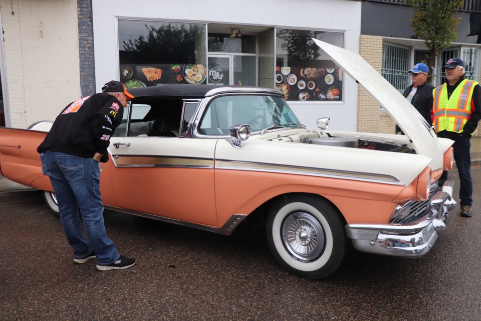 A vintage automobile admirer takes a look at Ken Sack's 1957 Ford Fairlane 500 at the Innisfail Kinsmen Car Show on Sept. 12. Johnnie Bachusky/MVP Staff