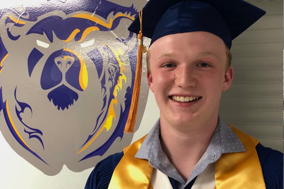 Valedicatorian Wade Longeway poses for a photo prior to Thursday's graduation ceremony
