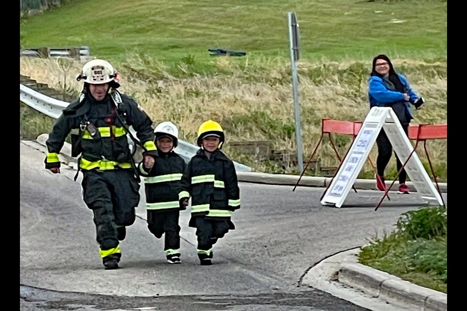 Innisfail fire chief Gary Leith with his grandsons Lukas (centre) and Spencer at the finish line after their participation on June 5 in the 8th annual Firefighter Stairclimb Challenge in Calgary. 
Submitted photo