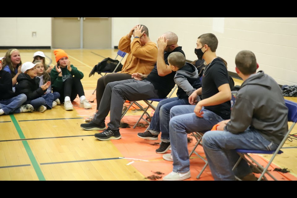 Tiffany and Joe Faught check out their newly-shaved heads as others look on.
Doug Collie/MVP Staff