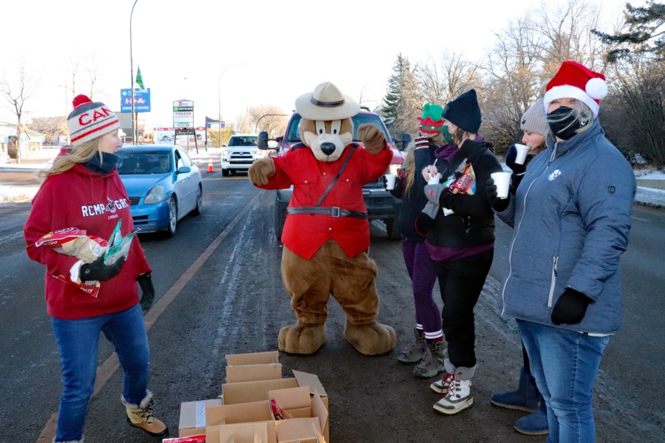 The RCMP Safety Bear does a dance shuffle for volunteers helping out at the 25th Annual Charity Check Stop along Main Street on Dec. 11. The event raised a record sum of cash to help the less fortunate in the community. 
Johnnie Bachusky/MVP Staff