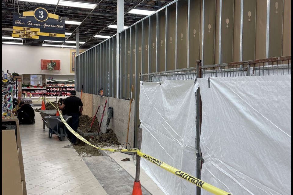 A worker tends to renovation along the floor in the Westview Co-op Food Store in Olds.
