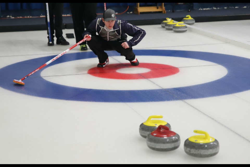 Olds skip Cody Maetche watches as a rock heads toward the house during the D side final of the Alberta Firefighters Championship Bonspiel, held Feb. 1-3 at the Olds Curling Club.