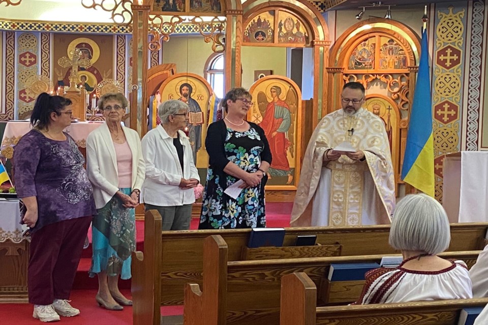 A delegation from the Catholic Women's League (CWL) of Innisfail's Our Lady of Peace Catholic Church presented Father Jim Nakonechny of the St. Vladimir Ukrainian Catholic Church Red Deer with a cheque for $2,295 on June 26. The money was raised by the CWL at a cookie sale they held last month east of Innisfail. Submitted photo 