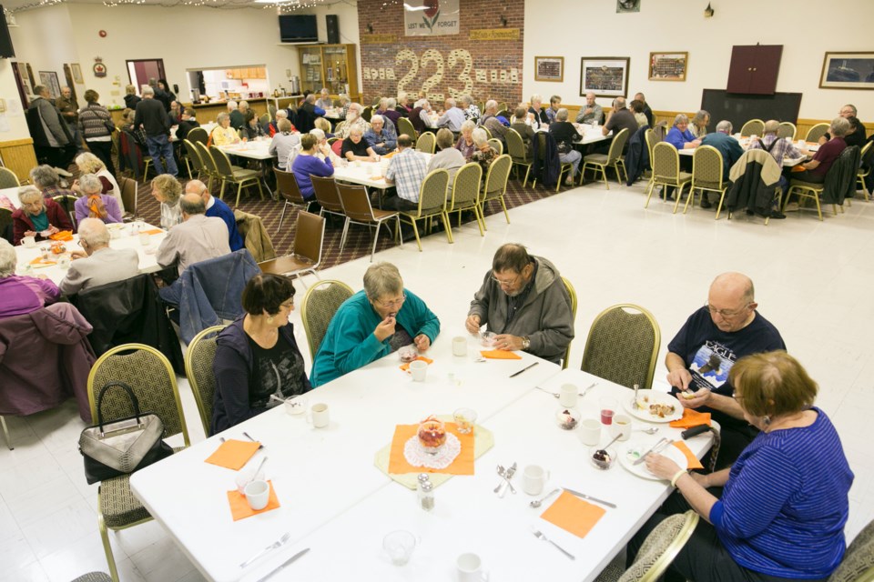 Guests enjoy a meal as well as the opportunity to socialize during a monthly Cooking for Kindness luncheon at the Royal Canadian Sundre Legion Branch #223 Hall in this file photo from 2017. After being cancelled last year because of the pandemic, the annual Sundre Community Christmas Dinner is set to return on Dec. 25 from noon to 3 p.m. under the provincial government’s Restrictions Exemption Program. 
File photo/MVP Staff