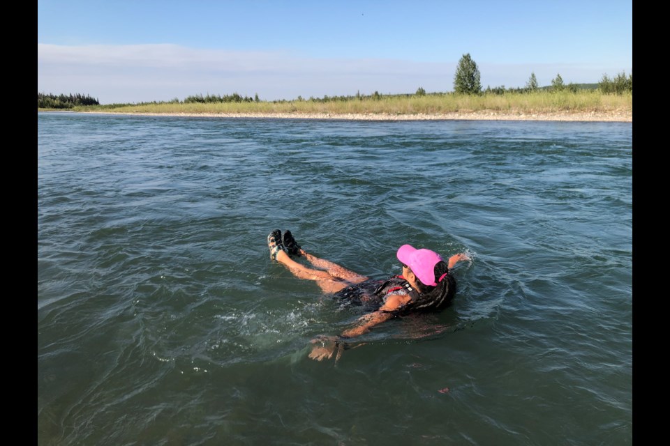 Donning a personal flotation device, a Sundre resident enjoys a rather refreshing dip in the cool, rejuvenating waters of the Red Deer River on Aug. 1 amid some sizzling summer temperatures. 
Simon Ducatel/MVP Staff