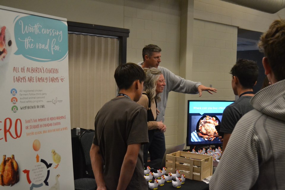 Students check out a booth about raising chickens during Cultiv8, a province-wide youth summit on agriculture, held Oct. 20-23 at the Olds College of Agriculture & Technology. 