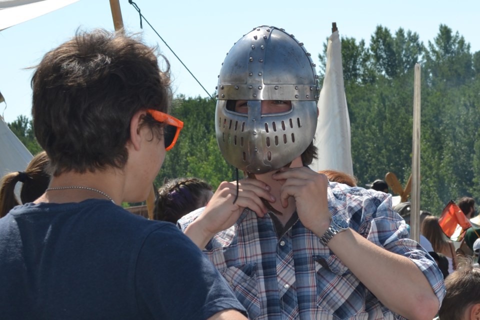 A Days of Yore attendee tries on a medieval combat mask, one of many items the Dragon’s
Own combat re-enactment group had on hand July 30 and 31.
Lea Smaldon/MVP Staff