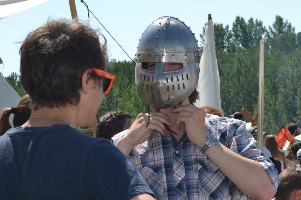 A Days of Yore attendee tries on a medieval combat mask, one of many items the Dragon’s
Own combat re-enactment group had on hand July 30 and 31.
Lea Smaldon/MVP Staff