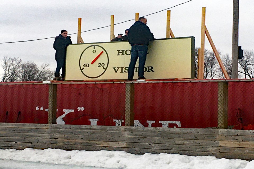 Production workers at the outdoor rink in Delburne that is being used as a filming location for the upcoming Alberta-made movie Ties That Bind recently installed a newly created scoreboard clock. Photo by Jason Reckseidler