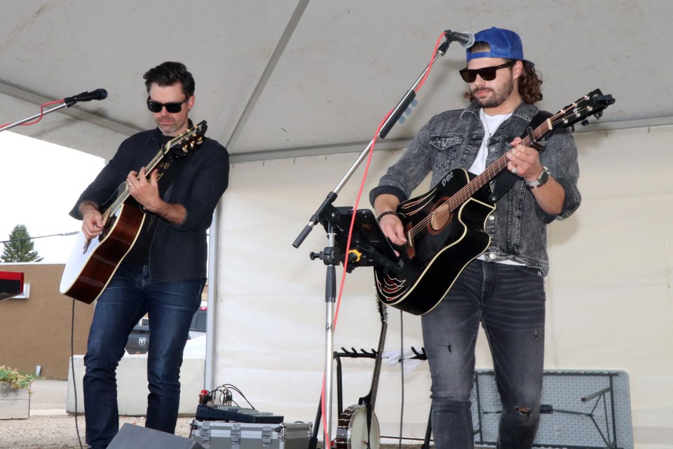 Local recording artist Devin Cooper, right, blasts out the tunes with Calgary's Brendan Waters during this year's final Market On Main in downtown Innisfail on Sept. 14. Johnnie Bachusky/MVP Staff