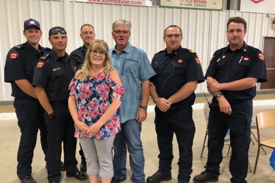 Diane and Ray Kellsey pose for a photo with Carstairs fire department members during the Sept. 15 event in Carstairs. 
Dan Singleton/MVP Staff