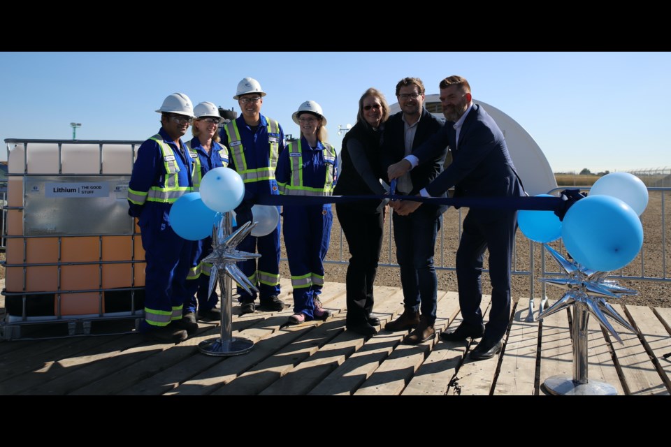Mountain View County Reeve Angela Aalbers, E3 Lithium CEO and founder Chris Doornbos, and Energy and Minerals minister Brian Jean cut the ribbon as E3 employees, from left, Pritam Saha, Lelanie de Kock, Roy Ren and Caroline Mussbacher look on.