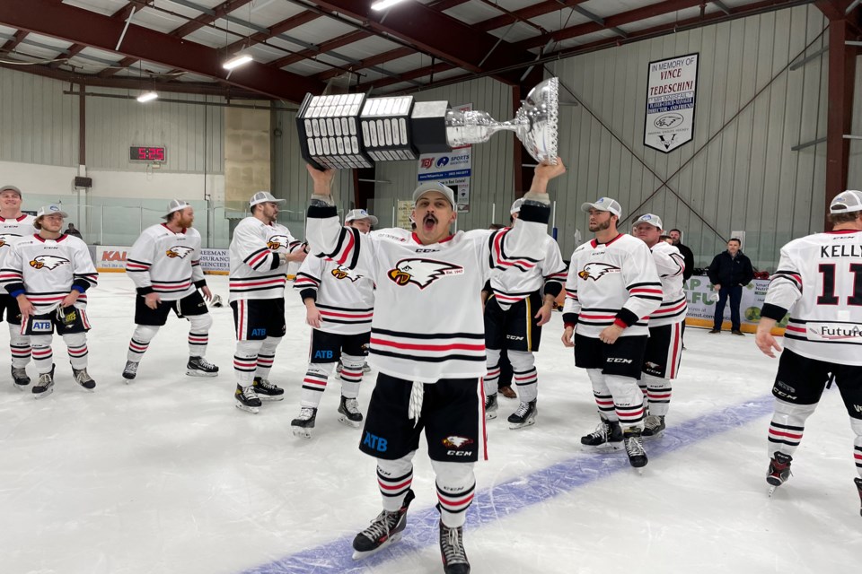 Innisfail Eagles' Mike Marianchuk celebrates with his teammates with the raising of the senior men's hockey provincial championship trophy following the team's victory over Stony Plain on March 18 at the Innisfail Twin Arena. 
Johnnie Bachusky/MVP Staff