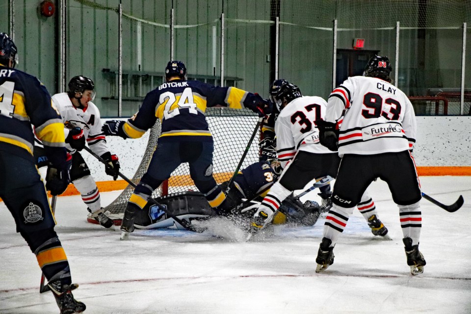 The Innisfail Eagles crash the net against beleaguered Stony Plain goalie Ty Rimmer during intense regular season action on Feb. 25 at the Innisfail Twin Arena. 
Johnnie Bachusky/MVP Staff