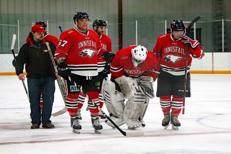 Eagles starting goalie David Fisher being helped off the ice by his teammates after being injured during the second period of the game on Jan. 15 against Nanton. He was replaced by emergency back-up Jason Reckseidler. Johnnie Bachusky/MVP Staff