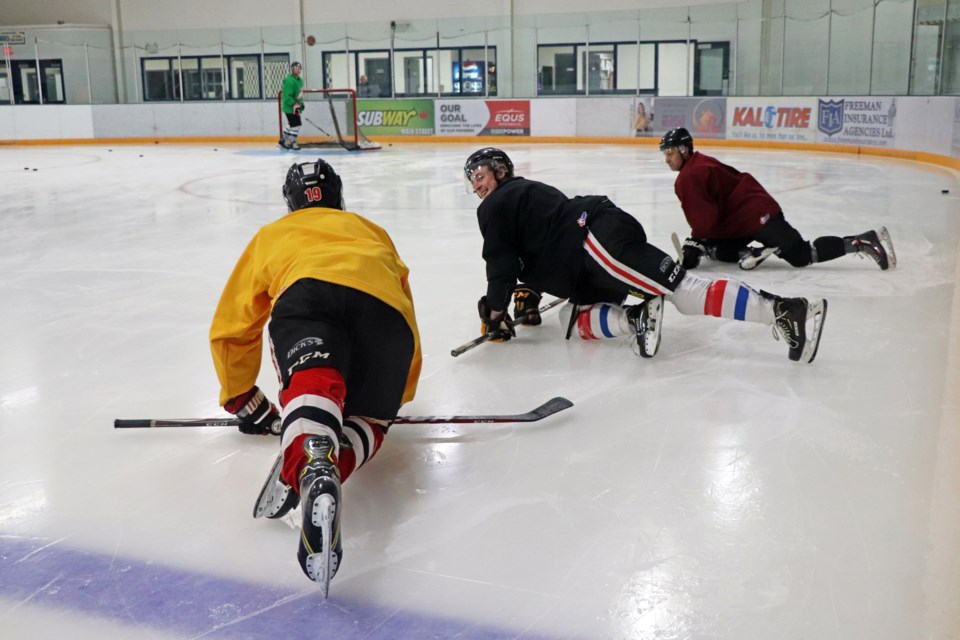 A trio of Innisfail Eagles hopefuls stretch out on the ice during the team's first pre-season practice at the Innisfail Twin Arena on Sept. 21. Johnnie Bachusky/MVP Staff