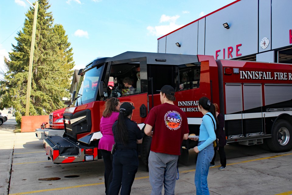 Attendees at Innisfail's Emergency Preparedness Week Open House and BBQ on May 3 get a full lesson from a local firefighter on the department's emergency response equipment. Town of Innisfail photo