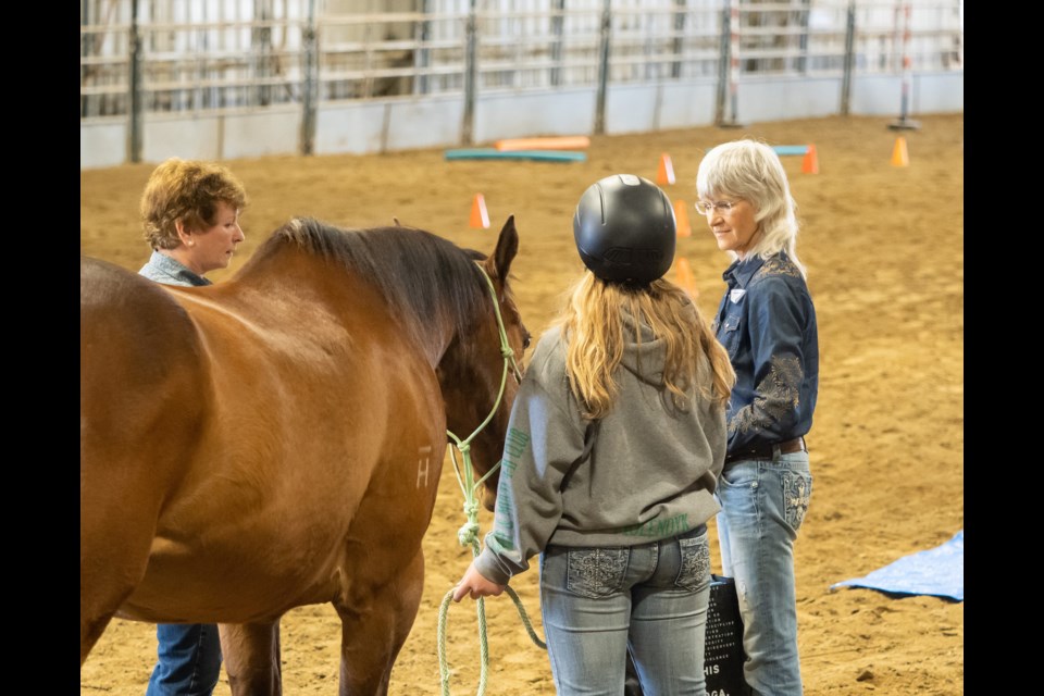 Horizon Equine EFW owner/operator Colleen Herzog and equine specialist Tahn Townes work with a student in the program.