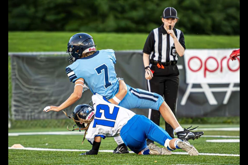 Team Alberta's Lillian Watkinson (number 12) makes a tackle during the championship game on July 29 against Team Québec at the 2023 U18 Women’s Football Championship. Photo by Roch Lambert