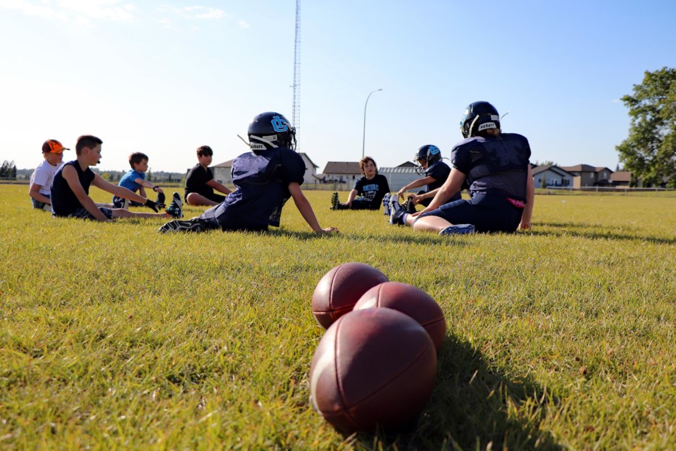 Players from the Innisfail Cyclones Bantam team go through stretching exercises during their Aug. 25th practice. Johnnie Bachusky/MVP Staff