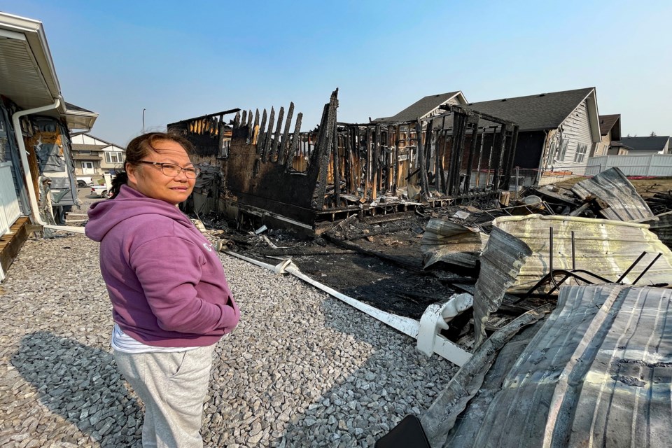 Grace Gresos at the ruins of her Hazelwood Estates home in Innisfail on May 17, a day after the house was destroyed by a devastating fire. The family of seven was left homeless but the community is rallying to help.  Johnnie Bachusky/MVP Staff
