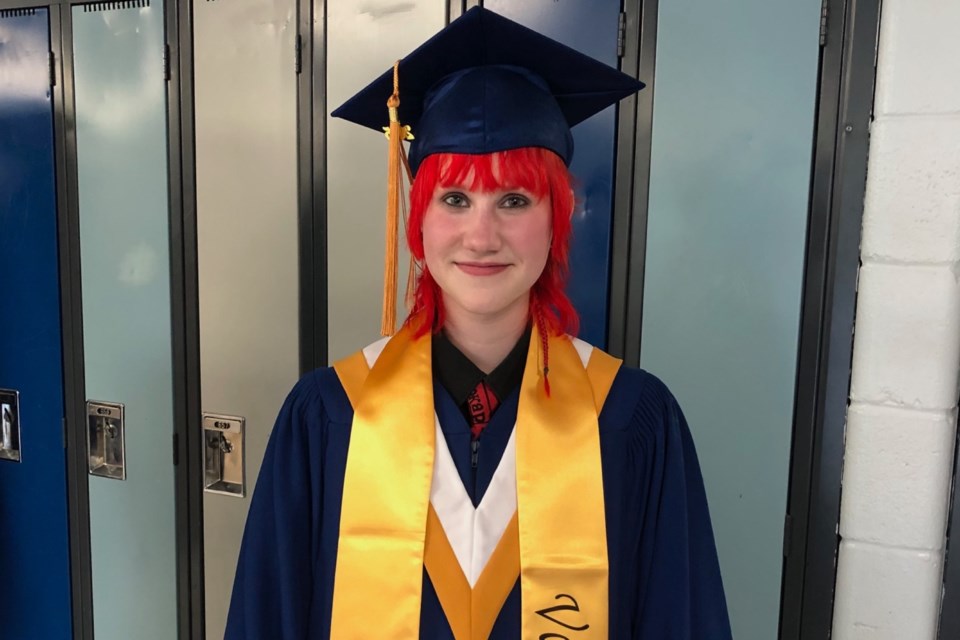 Valedictorian Hilary Pawluk poses for a photo as graduates prepared to enter the gymnasium.