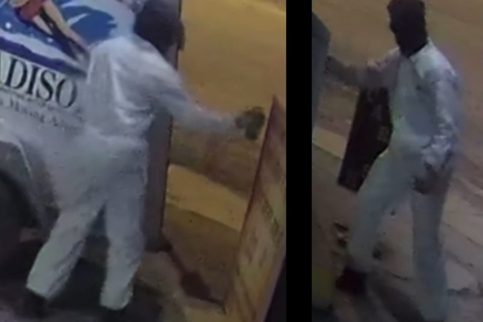 Police are looking for a suspect who was captured on CCTV spray-painting discriminatory graffiti on a sign at the Sundre Car Wash at approximately 12:45 a.m. on Friday, April 11. 
RCMP handout