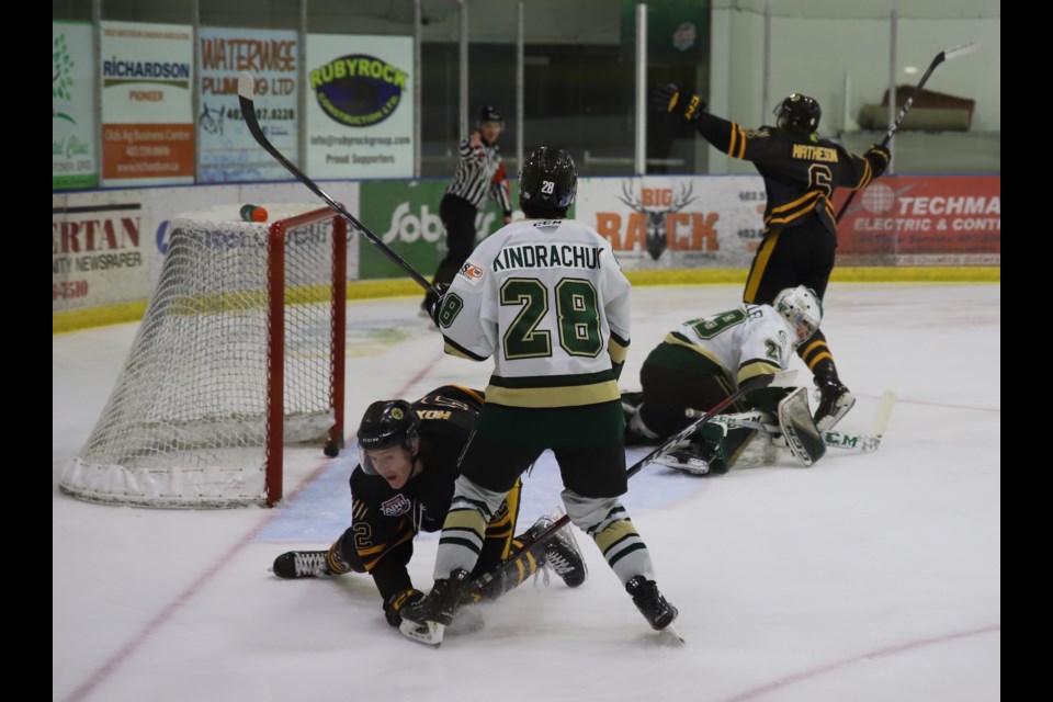 Grizzlys defenceman Blake (6) Matheson celebrates after scoring a goal during a game between the Grizzlys and Okotoks Oilers held Feb. 3 at the Olds Sportsplex. Crouching on the ice in the foreground is Matheson's teammate Cade Moxham (22) who assisted on the goal. 