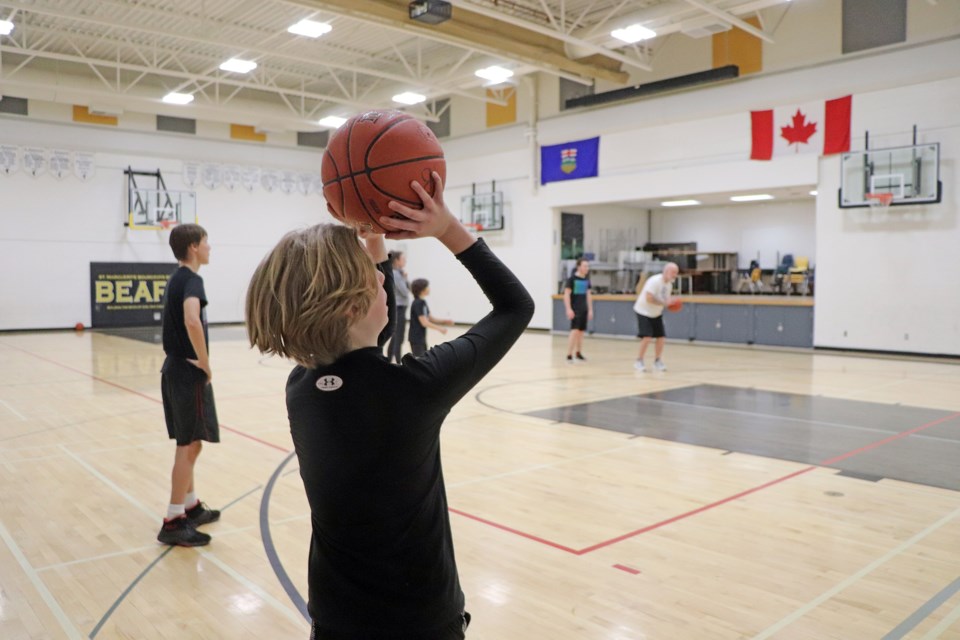 A young member of the senior boys basketball team at St. Marguerite Bourgeoys Catholic School takes a shot during a full after-school practice on Feb. 1. Johnnie Bachusky/MVP Staff