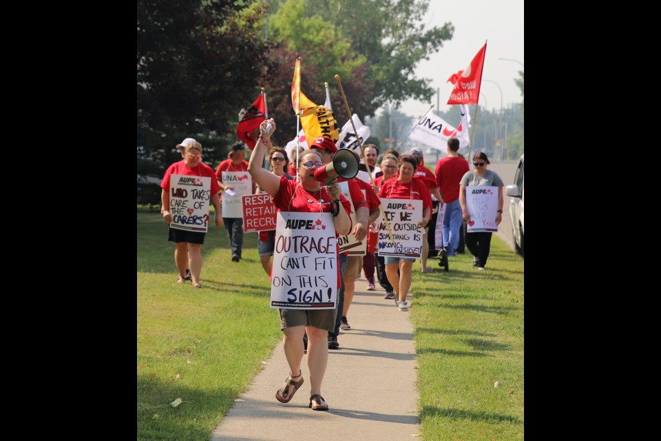 Those attending a rally held outside the Olds Hospital & Care Centre march along the sidewalk along 57th Avenue in front of the facility.
Doug Collie/MVP Staff